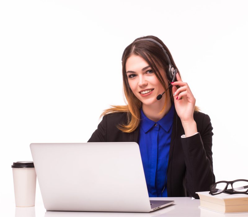 Portrait of smiling cheerful beautiful young support phone operator in headset with laptop, isolated over white background